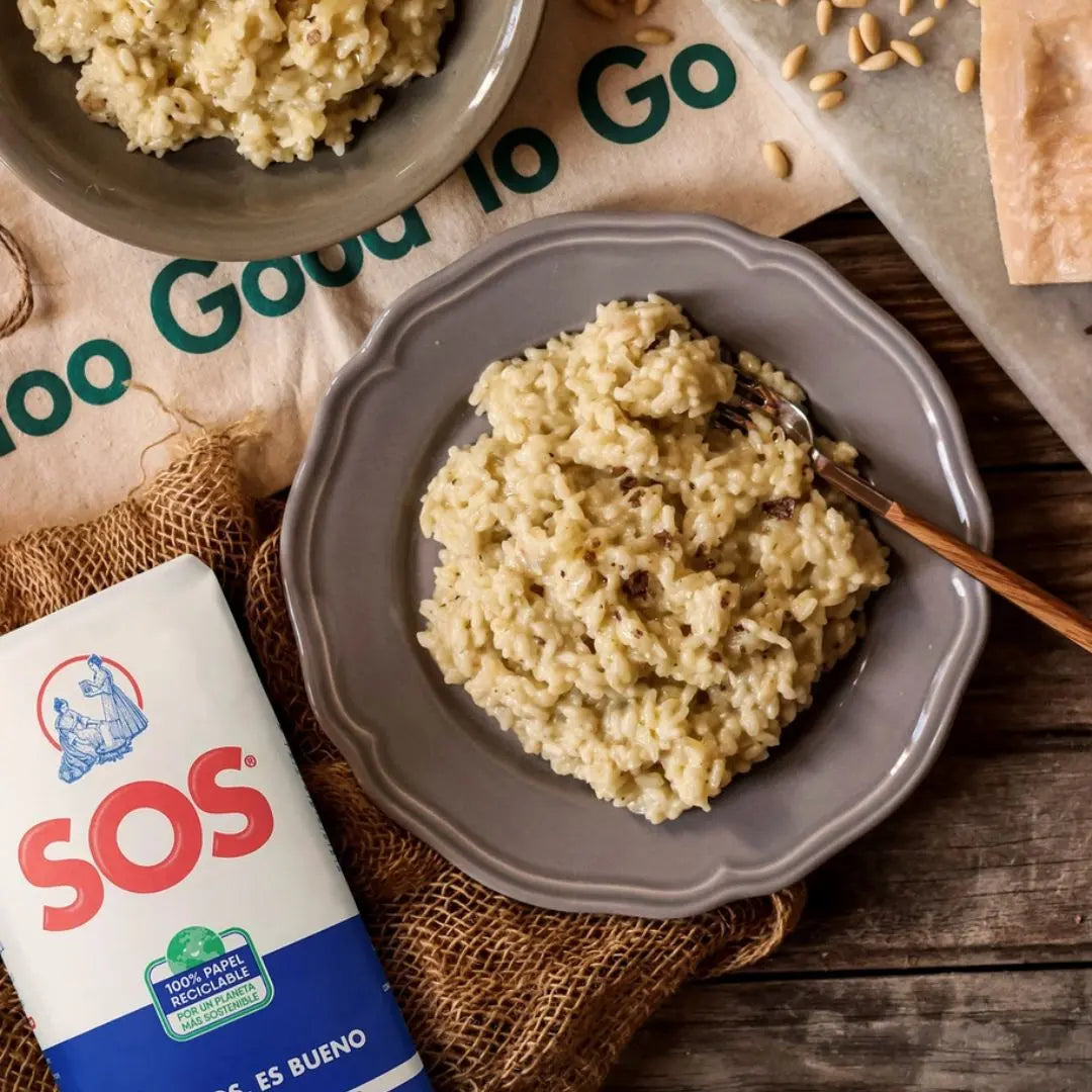  A plate of creamy risotto served with SOS rice, highlighting the rich texture of the dish on a rustic table.