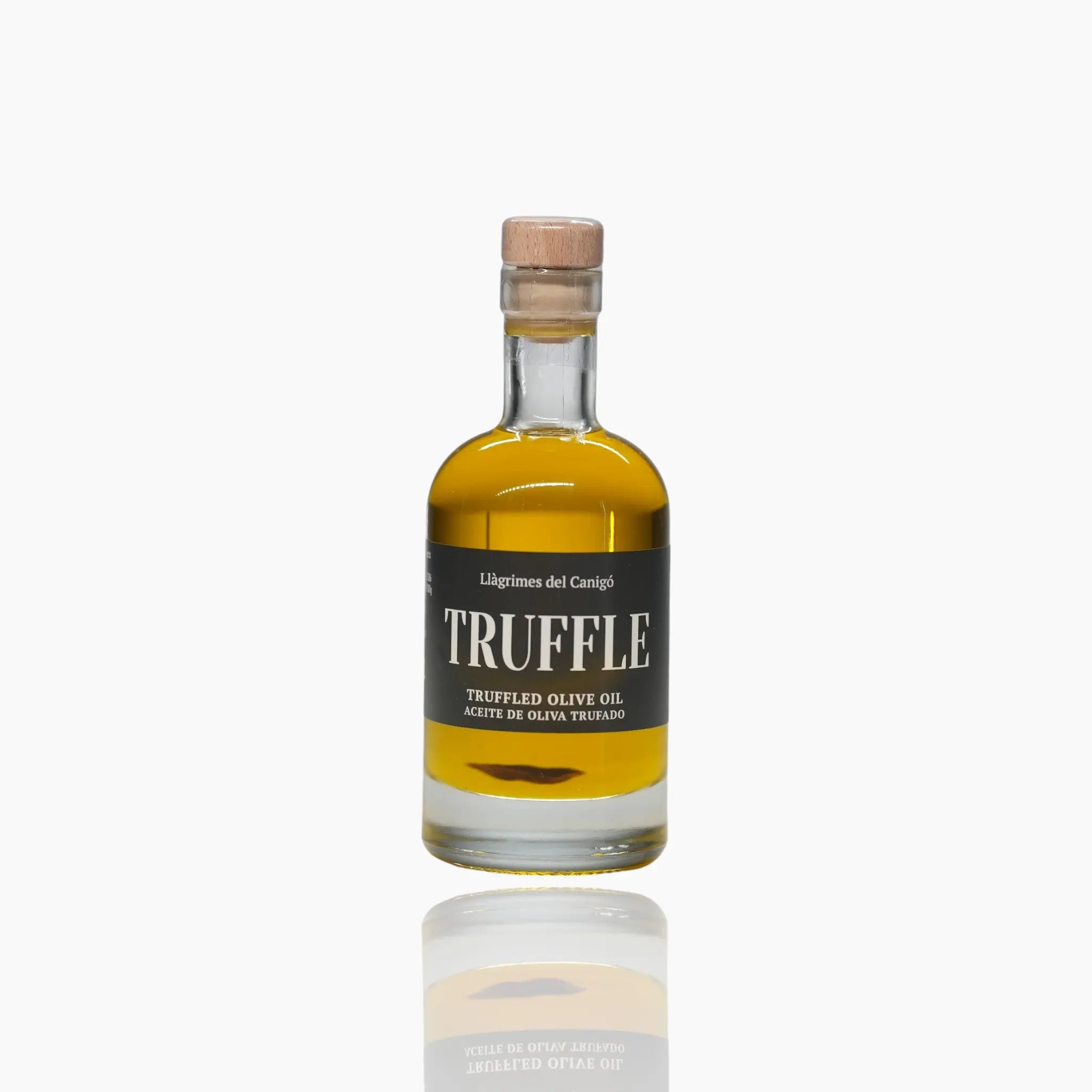 A 100ml glass bottle of premium truffle olive oil with a cork stopper and black label.